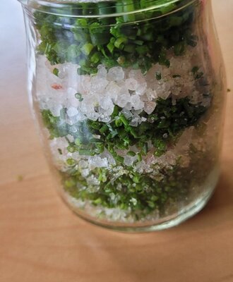 Glass jar with chives and salt.