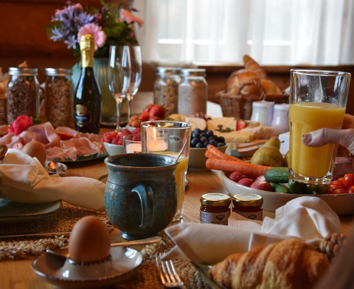 A rich and inviting breakfast in the holiday home, featuring fresh juice, pastries, and a variety of delicious treats.