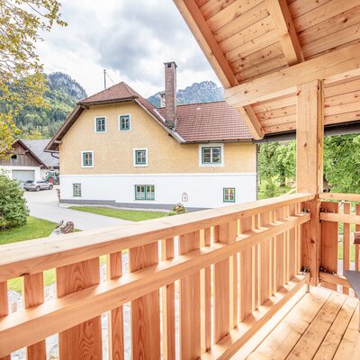 Wooden balcony overlooking the farm house and surrounding mountains.