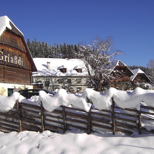 The Farm House property in a winter setting, featuring snow-covered buildings and a traditional wooden fence. The Farm House property in a winter setting, featuring snow-covered buildings and a traditional wooden fence.