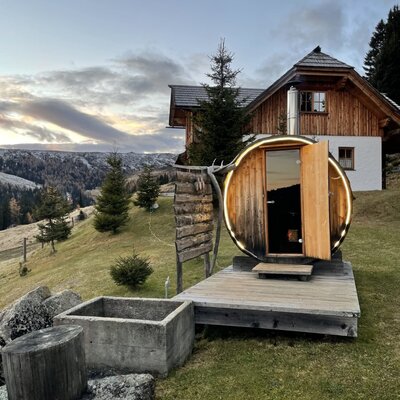 The Finnish outdoor sauna at the Bed and Breakfast, featuring a wooden deck and mountain views.