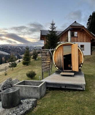 The Finnish outdoor sauna at the Bed and Breakfast, featuring a wooden deck and mountain views.