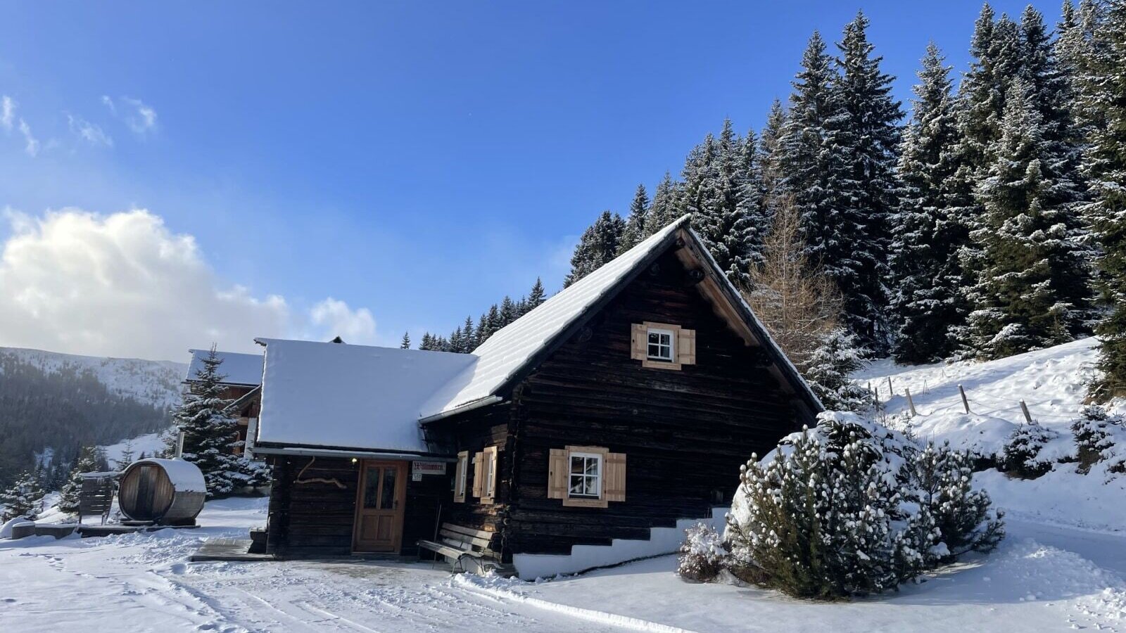 The snow-covered hut with the Finnish outdoor sauna.