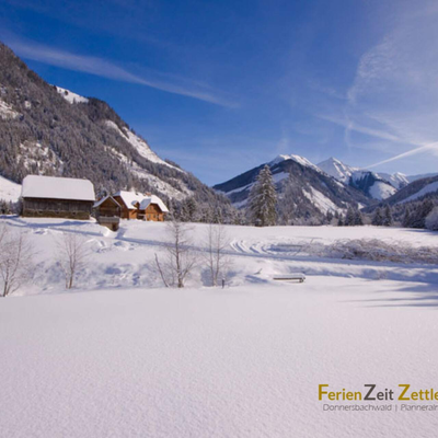 Winter landscape with snow-covered mountains and buildings in the surroundings of the Troadkasten.
