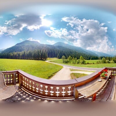 Balcony of the Troadkasten with mountain view and seating.
