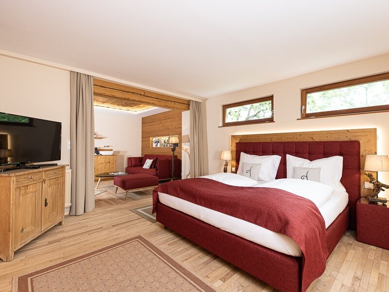Double bedroom in the farmhouse with a separate living area, featuring a sofa bed and a television.