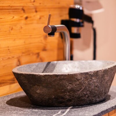 Stylish details like this stone washbasin highlight the modern design of our wellness area.