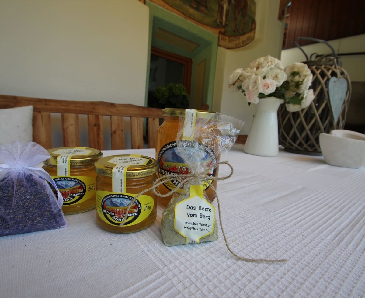 Local honey jars, a lavender sachet, and a mountain spice mix are presented on a table at the Farm House.