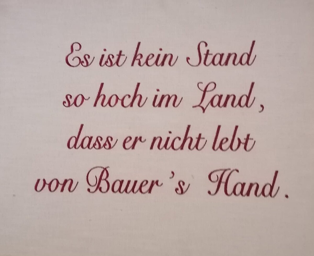 A German proverb displayed in the Farm House, highlighting the value of agricultural work.