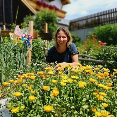 The farmhouse's colorful cottage garden featuring vibrant marigolds.