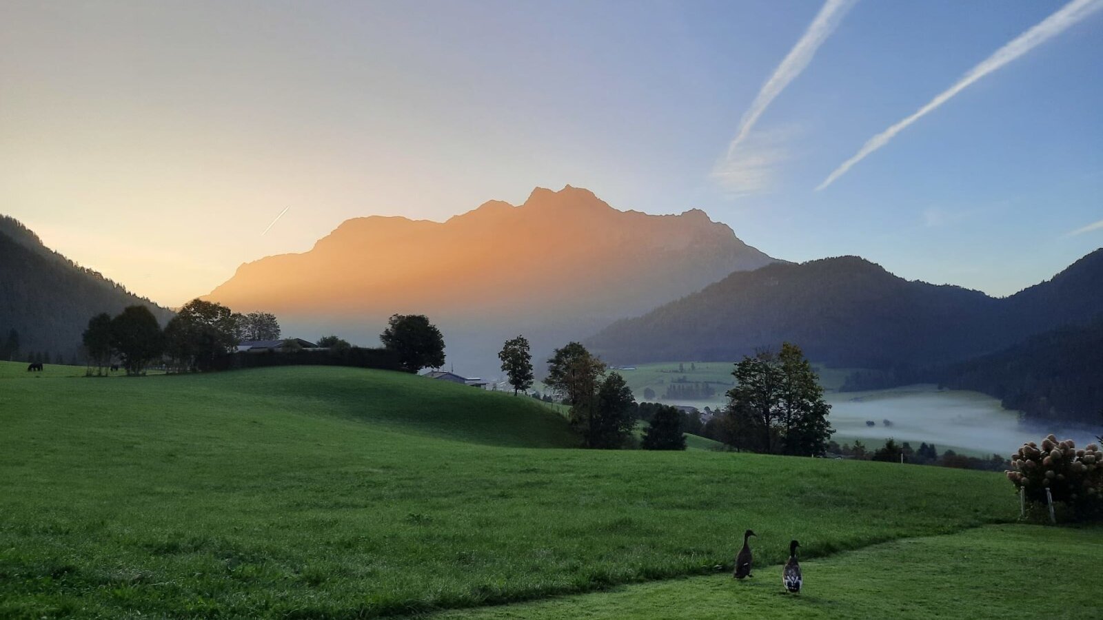 Scenic view from the apartments of the surrounding mountains bathed in the warm light of sunrise.