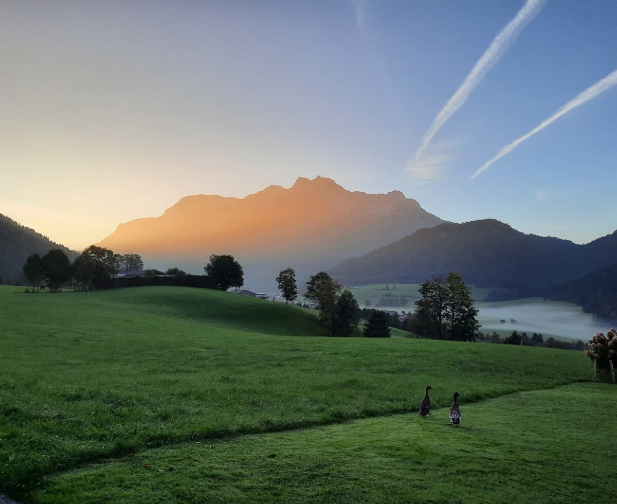 Scenic view from the apartments of the surrounding mountains bathed in the warm light of sunrise.