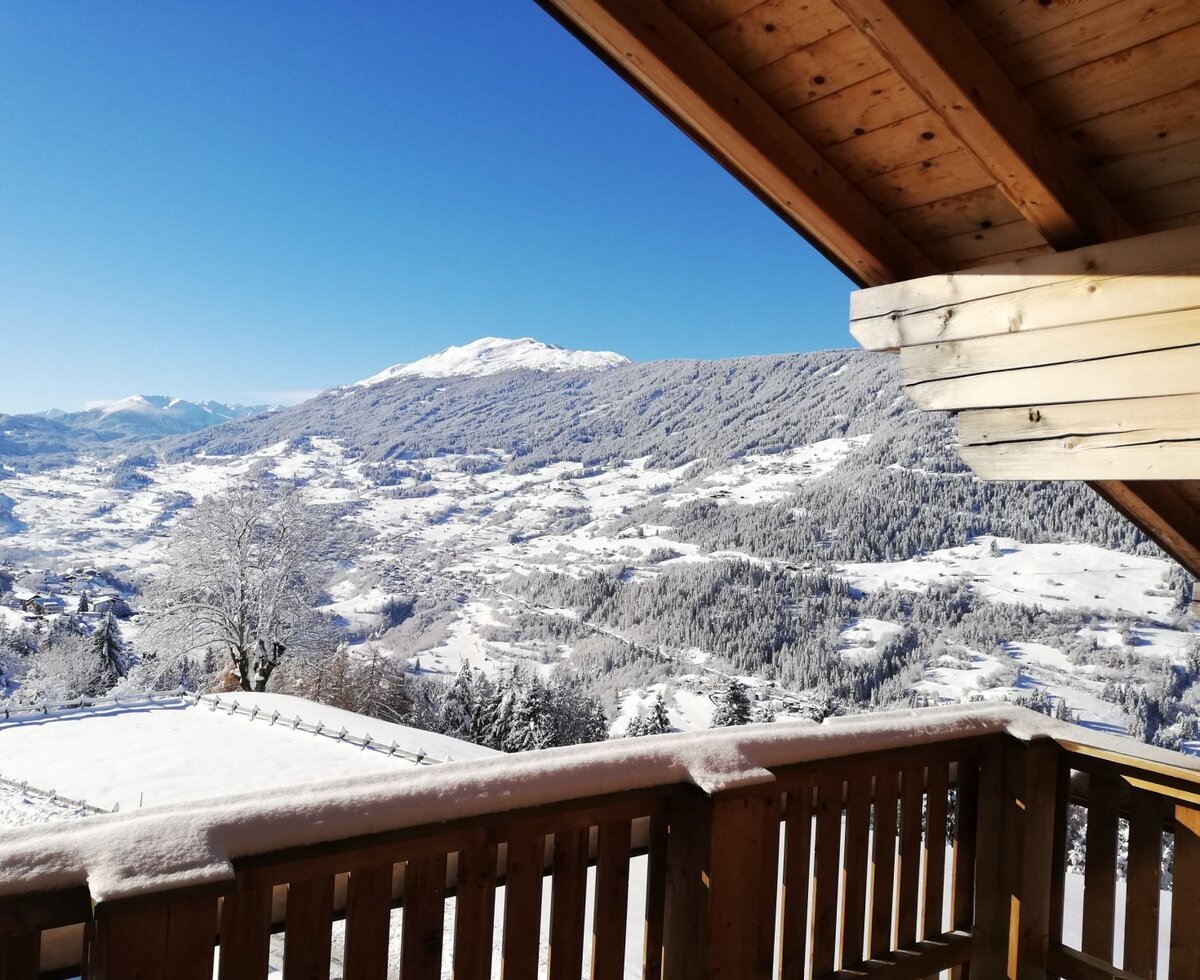 Panoramic view of the snowy mountains and valley from the farmhouse's south-facing sun terrace.