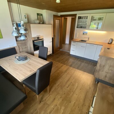 The farmhouse's fully equipped kitchen featuring a cozy dining area, warm wood accents, and modern appliances.