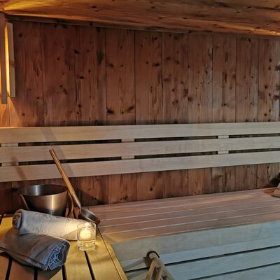 The farm house offers a sauna with wooden benches, a sauna bucket, ladle, and towels.