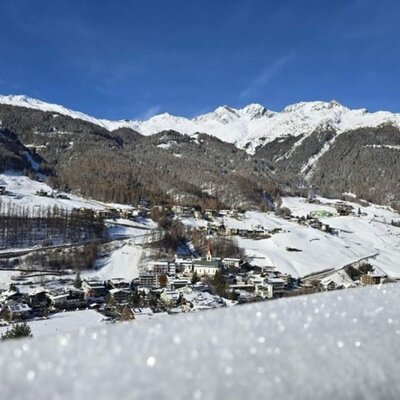 View of the snow-covered village and mountains from the farmhouse.