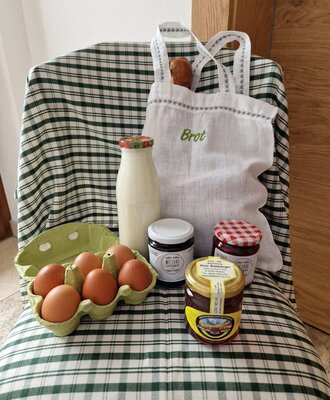 Fresh farm products including eggs, milk, bread, and jam from the farmhouse.
