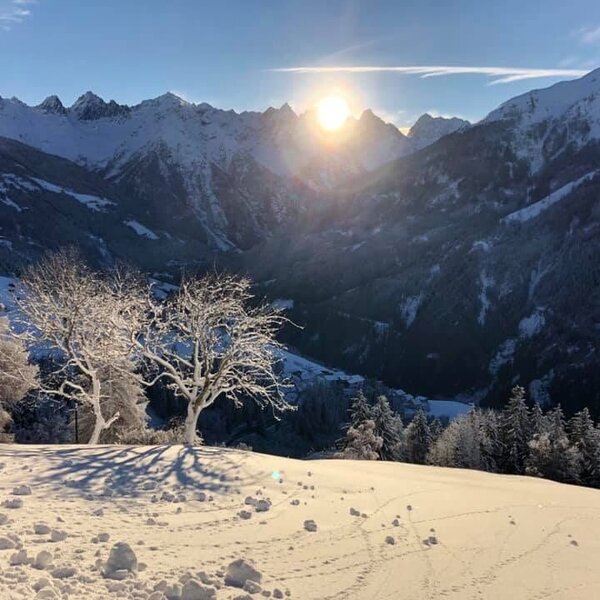 The winter mountain landscape surrounding the Farm House, showcasing snow-covered peaks, frosted trees, and a sunlit valley. The winter mountain landscape surrounding the Farm House, showcasing snow-covered peaks, frosted trees, and a sunlit valley.