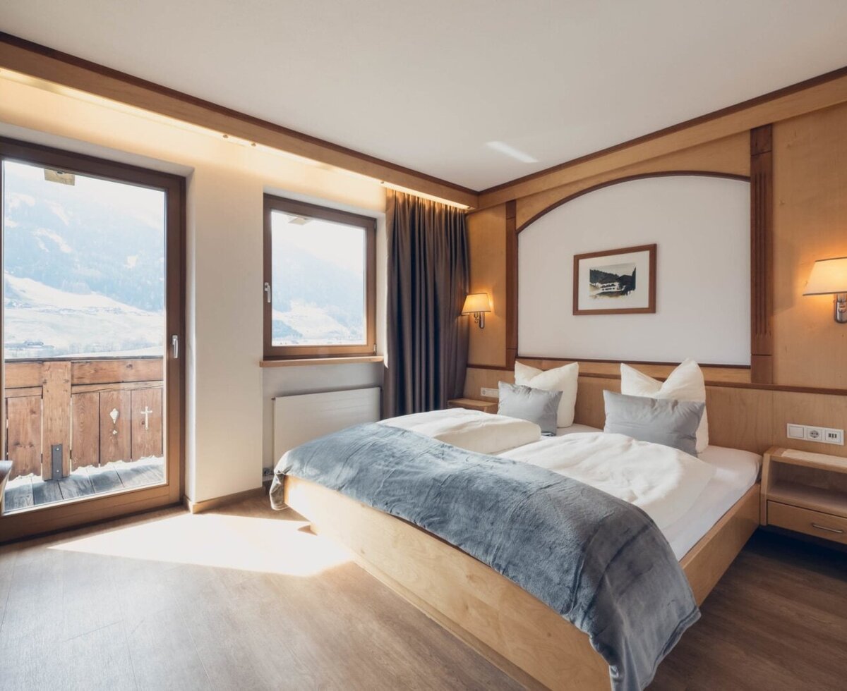 Comfort room with double bed, wardrobe, sitting area, flat screen TV, safe and balcony with a view