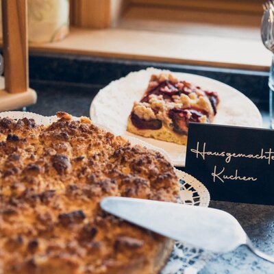 Rich breakfast buffet with homemade cakes such as fruit tarts, apple or curd strudel