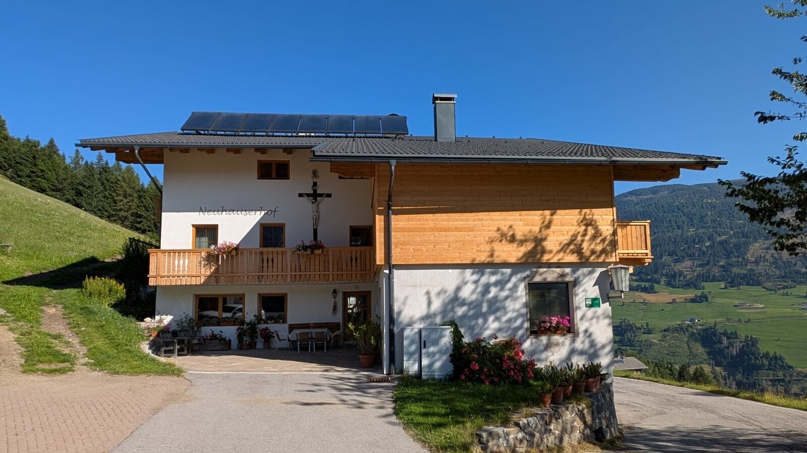 The farmhouse with balconies and a terrace overlooking the mountains.