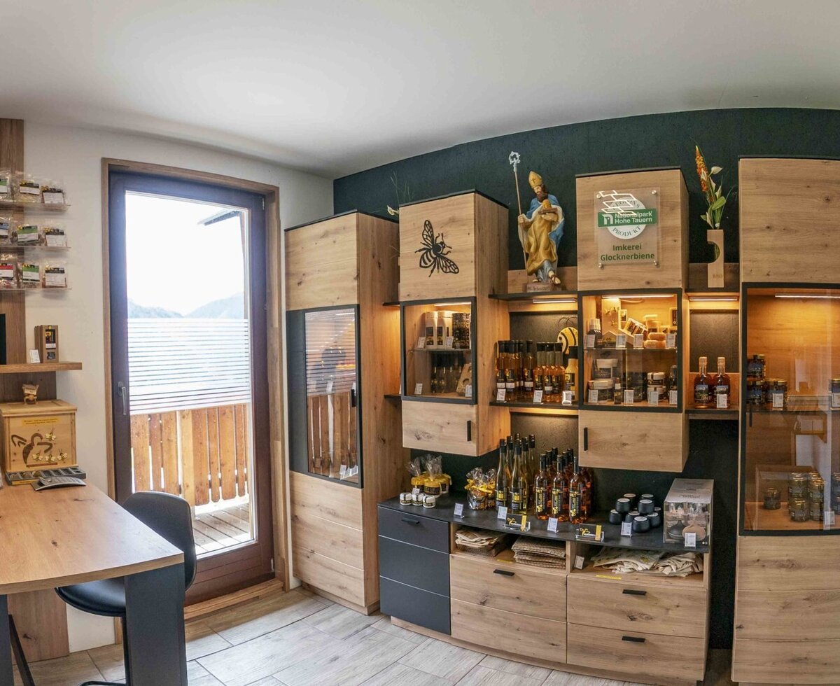 Shop area in the farmhouse with wooden shelves, local products, and access to the balcony.