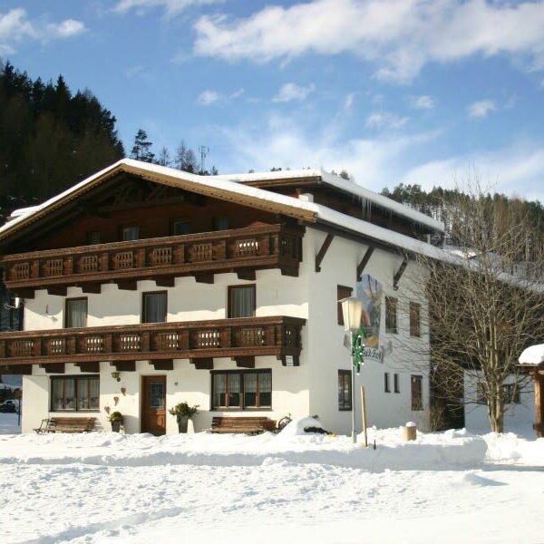 The Farm House exterior in winter, featuring multiple balconies and snow-covered grounds. The Farm House exterior in winter, featuring multiple balconies and snow-covered grounds.