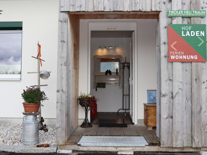 The inviting entrance of the appartements, featuring rustic wooden cladding and charming decorations.
