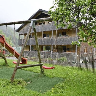 There are lots of places to swing, hide and play in our garden.