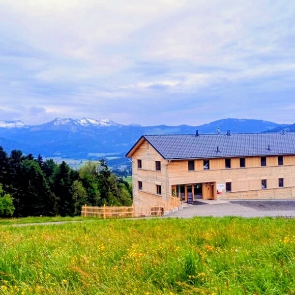 The newly built farmhouse in an idyllic, secluded location, surrounded by green mountain meadows with views of the Alps.