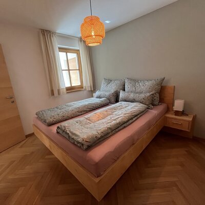 Bedroom with double bed at the Jäger family's holiday apartment in Braz/Vorarlberg