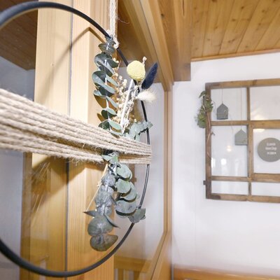 A decorative hoop with rope and dried botanicals, contributing to the interior decor of the Farm House.