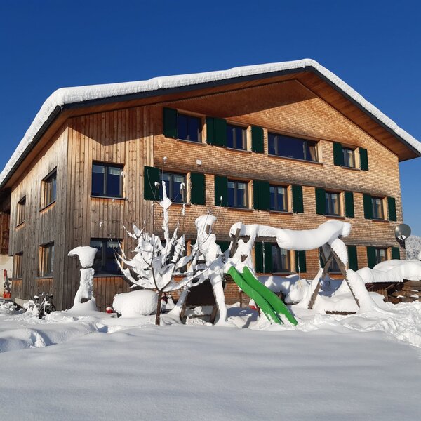 The Feurstein vacation farm in winter, featuring a snow-covered children's playground. The Feurstein vacation farm in winter, featuring a snow-covered children's playground.