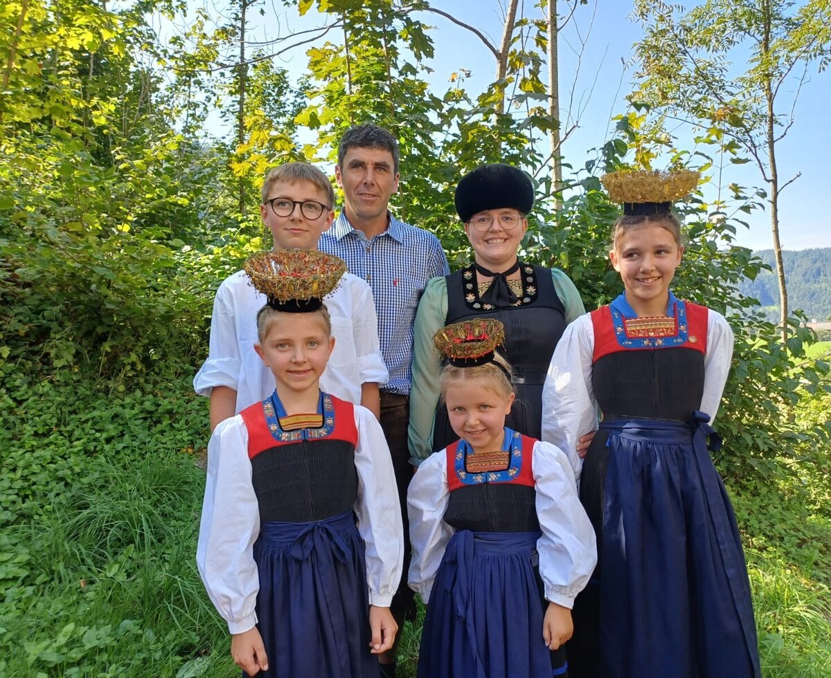 The Bauernhof family in traditional attire, representing the local culture.