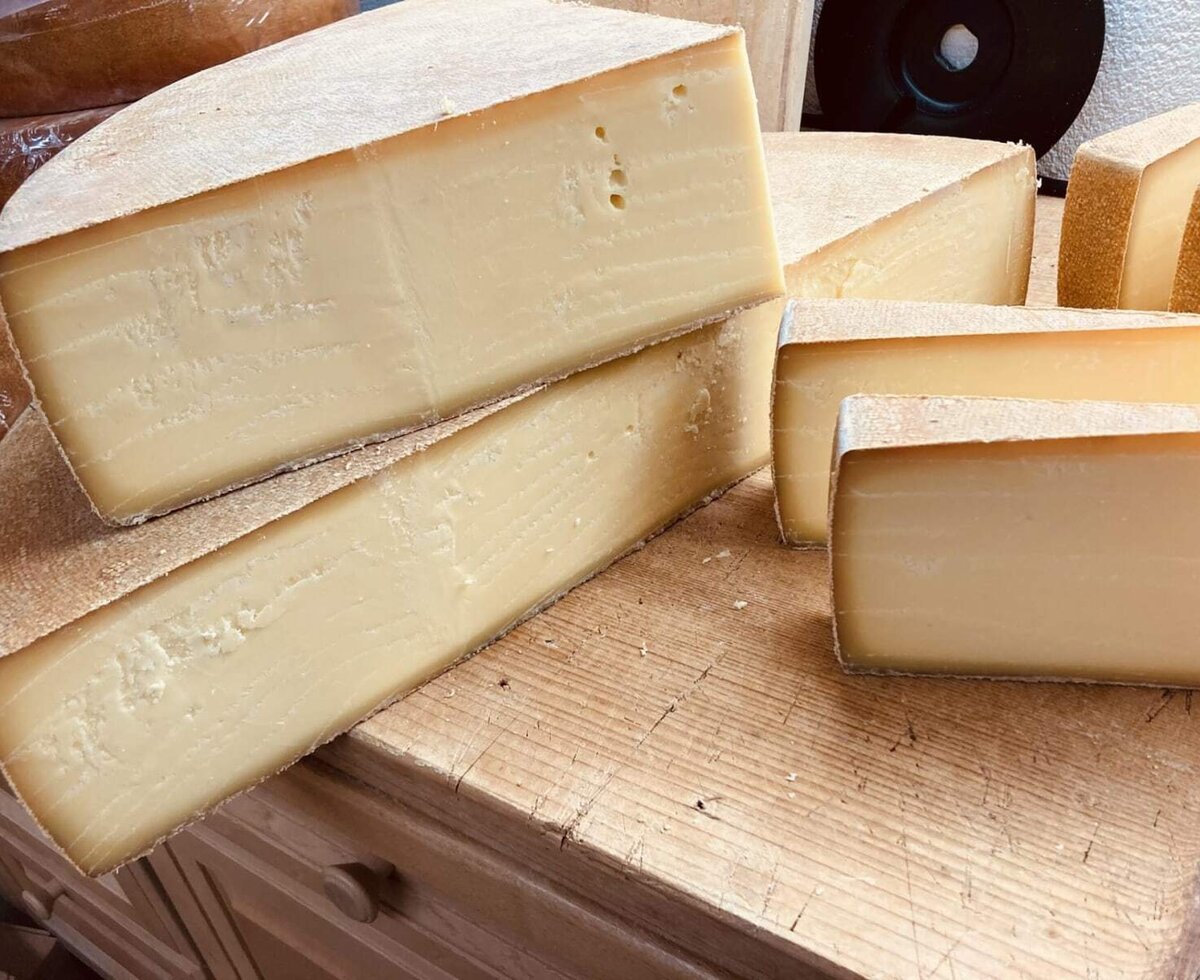 A selection of delicious, regional cheese on a rustic wooden board at the apartment.