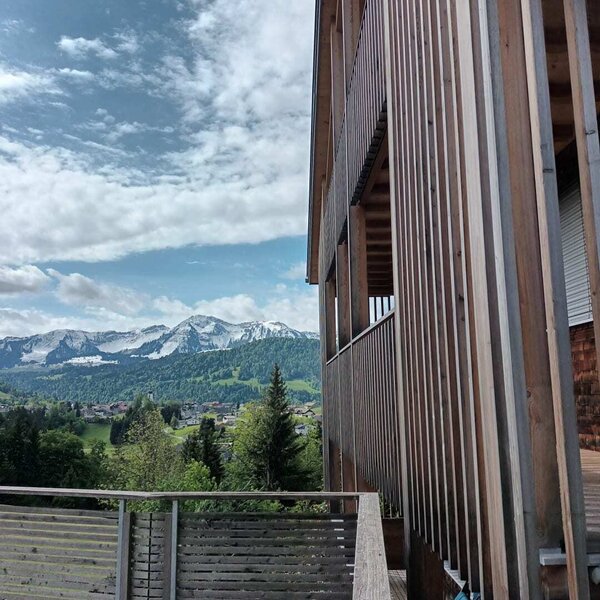 Balcony of the farmhouse with a view of the snow-capped mountains.