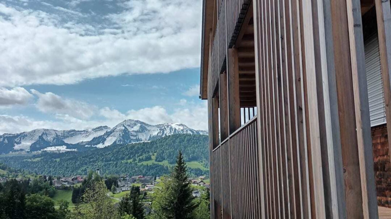 Balcony of the farmhouse with a view of the snow-capped mountains.