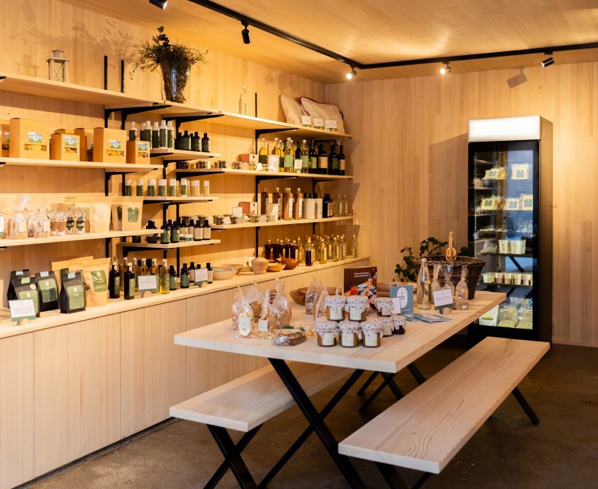 The bed and breakfast's inviting farm shop, featuring a wide selection of regional products and cozy wooden benches.