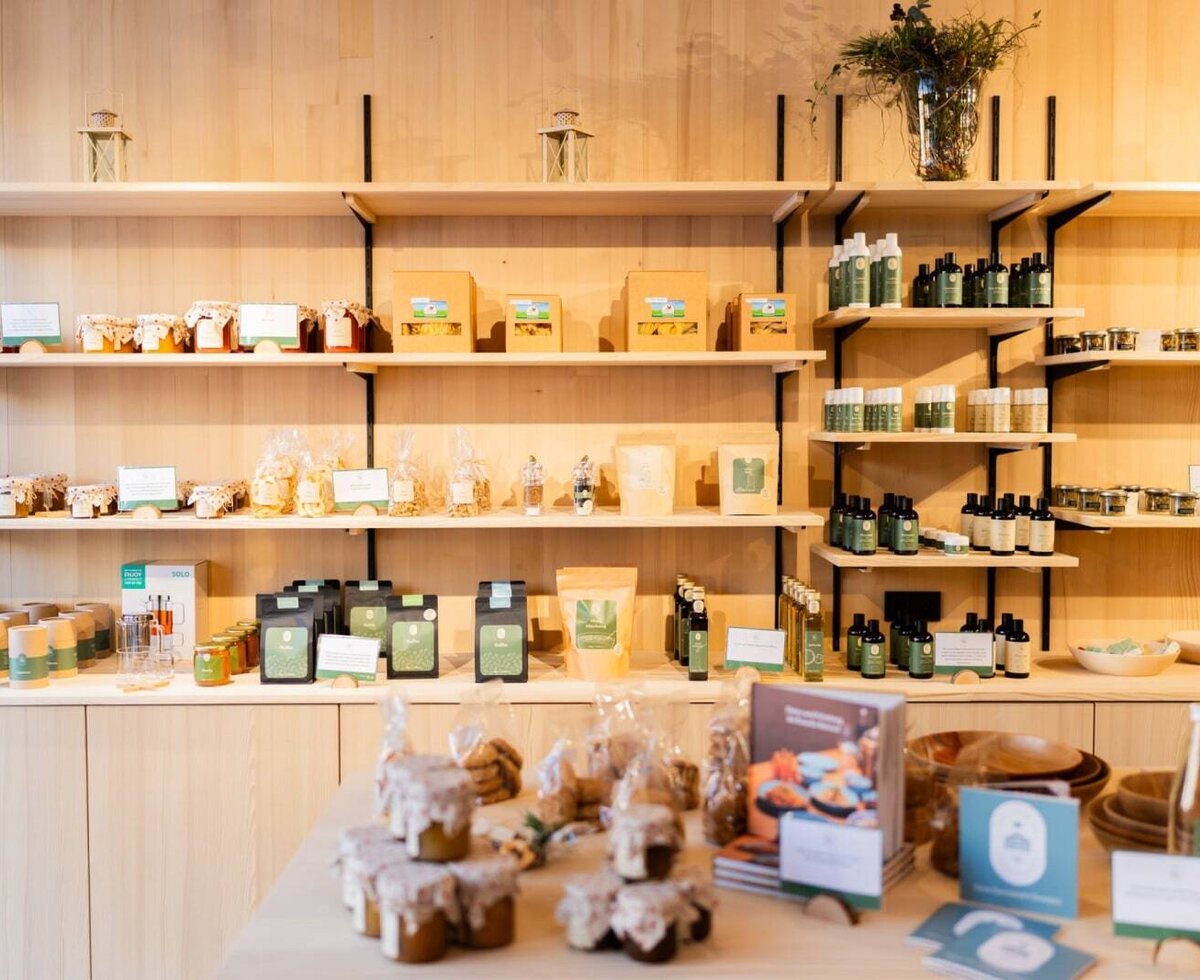 The bed and breakfast's inviting farm shop, featuring a variety of regional products beautifully displayed on light wood shelves.