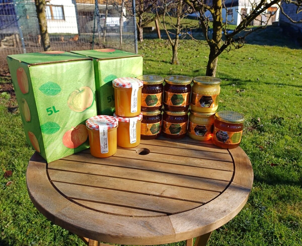 Jars of honey and apple juice boxes, available directly from the farmhouse.