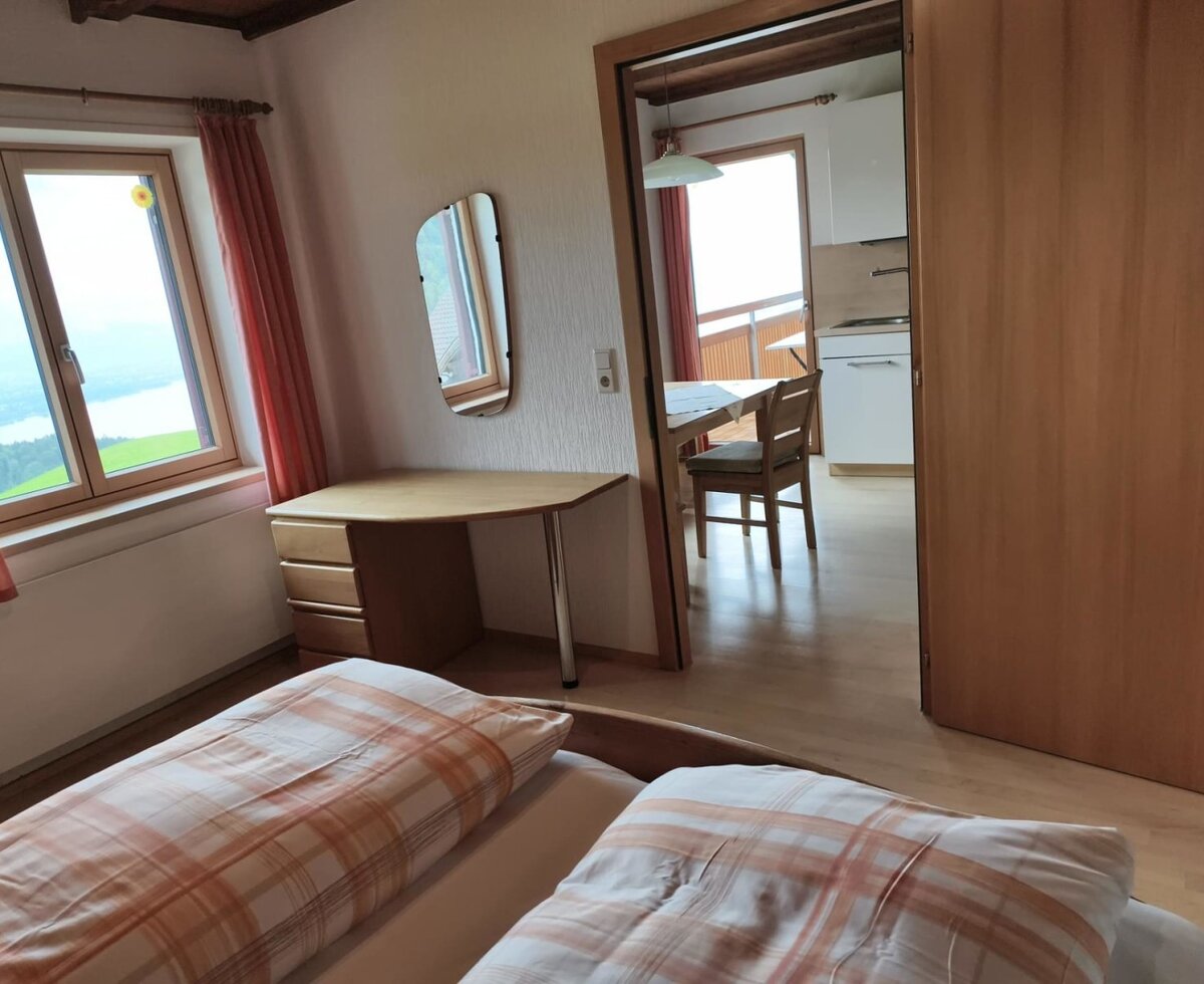 Bedroomof the apartment Dreiländerblick to the living kitchen with balcony.